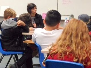 Becky speaking to a classroom